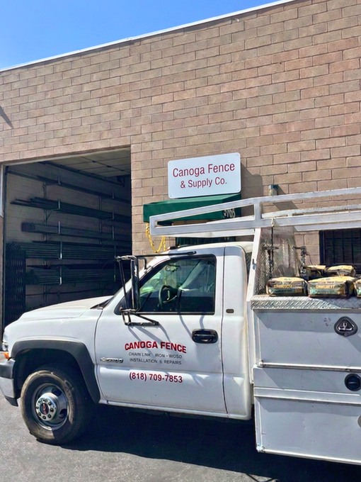 White truck with Canoga Fence lettering parked outside fence installer business in Chatsworth, CA.