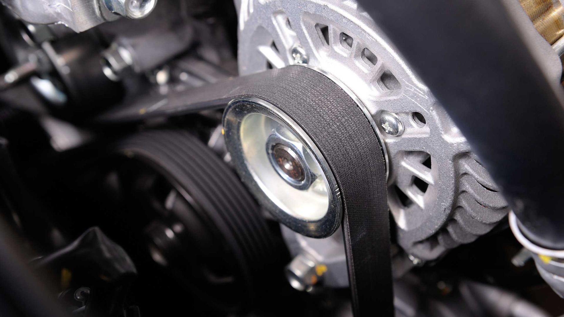 A close up of a belt on a car engine.