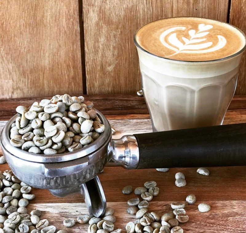 A Cup of Coffee Next to A Grinder Full of Coffee Beans — Nat’s Coffee in Kingscliff, NSW
