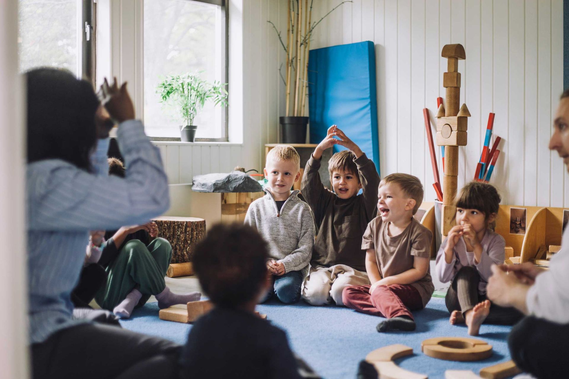 A teacher is teaching a group of children at a child care center. A teacher is teaching a group of children at a child care center.