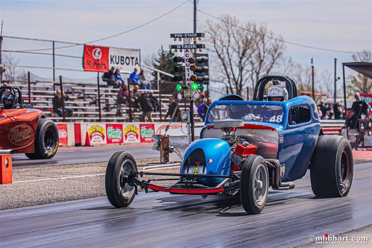 Two racing cars are racing on a race track.