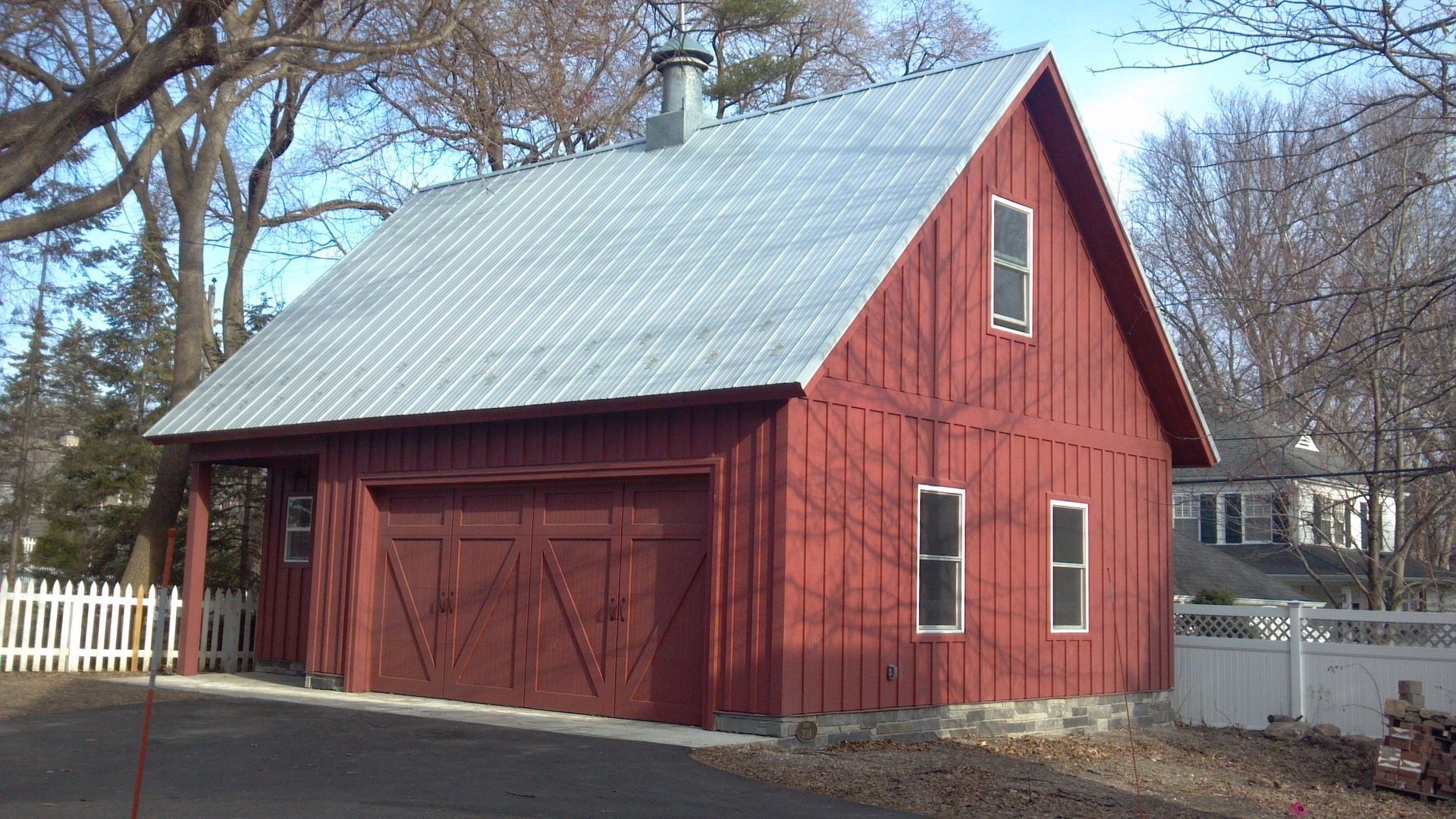 A large red barn with a metal roof