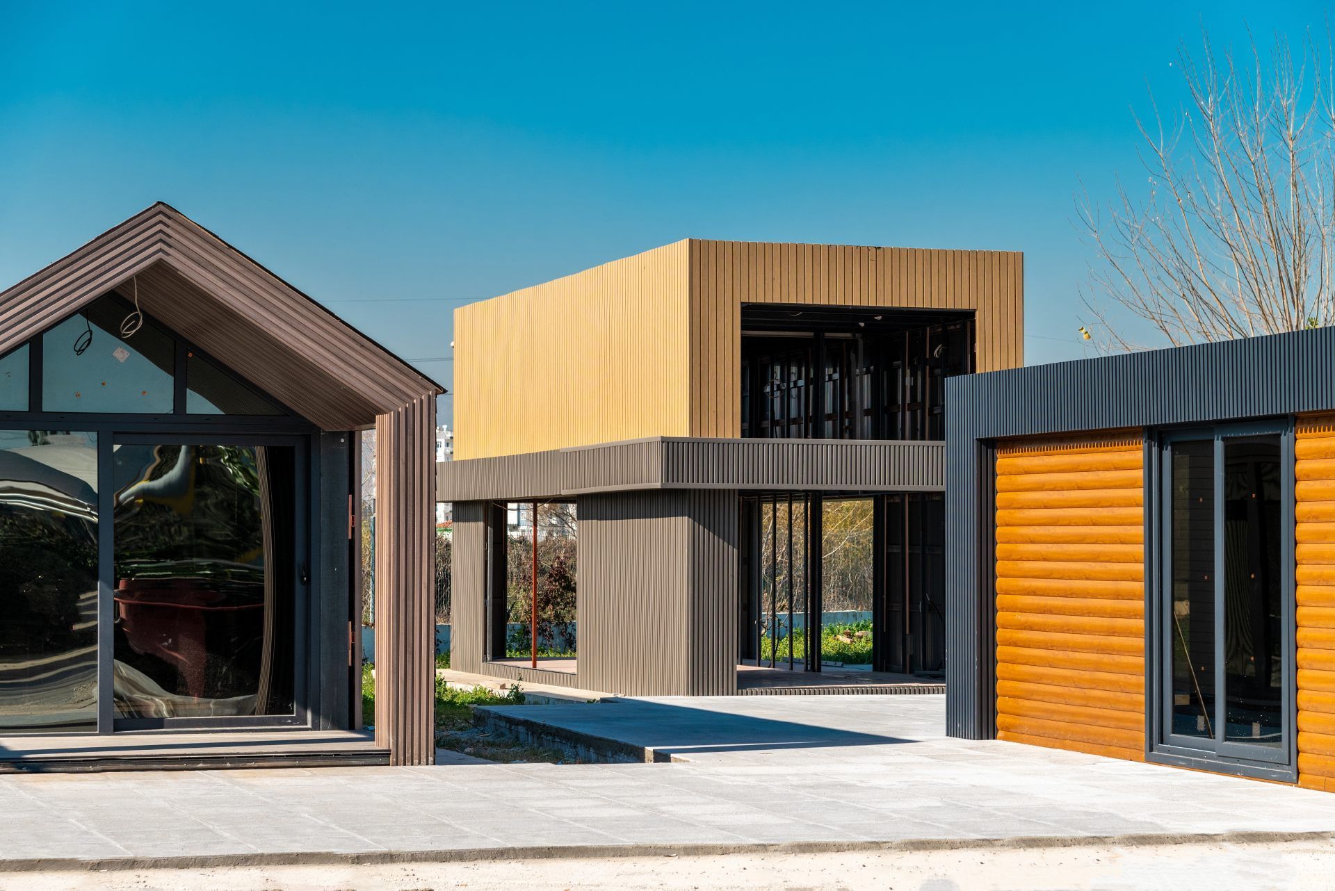 Modern modular buildings in various styles with blue sky background.