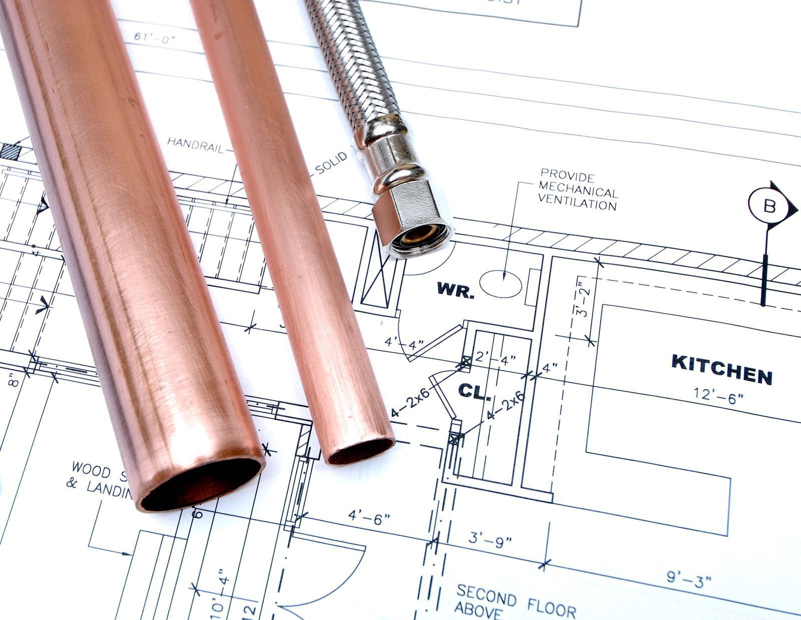 Copper pipes and flexible hose on a blueprint of a kitchen and other rooms.