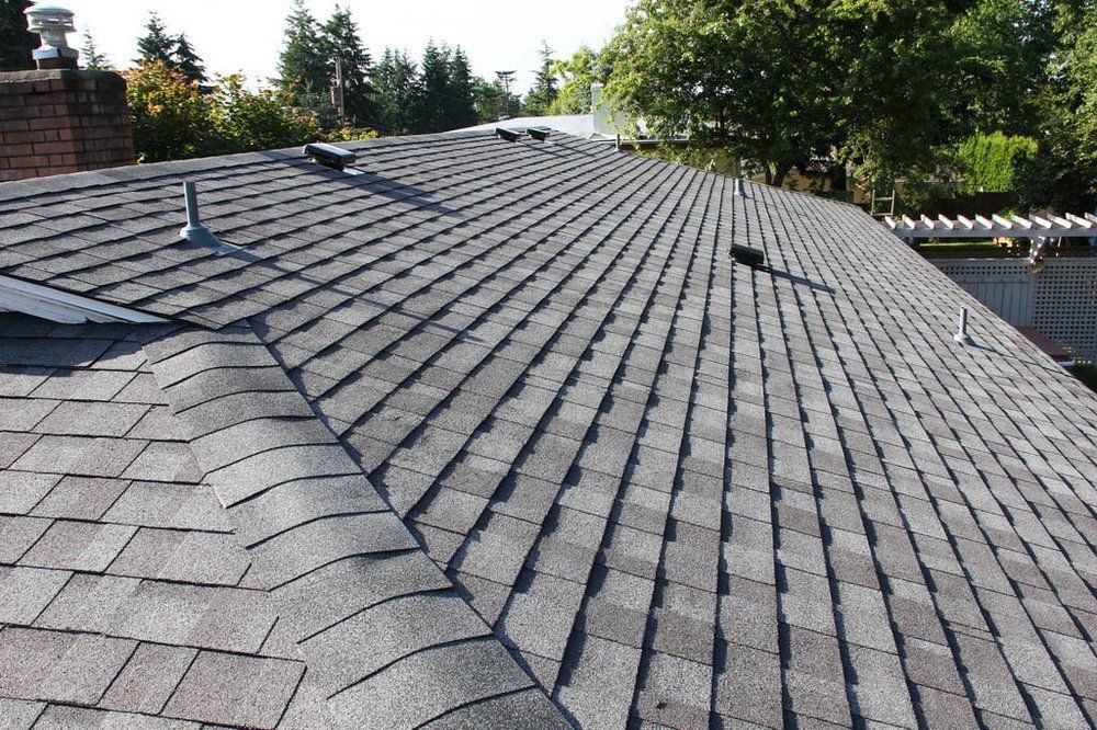 The roof of a house has a lot of shingles on it