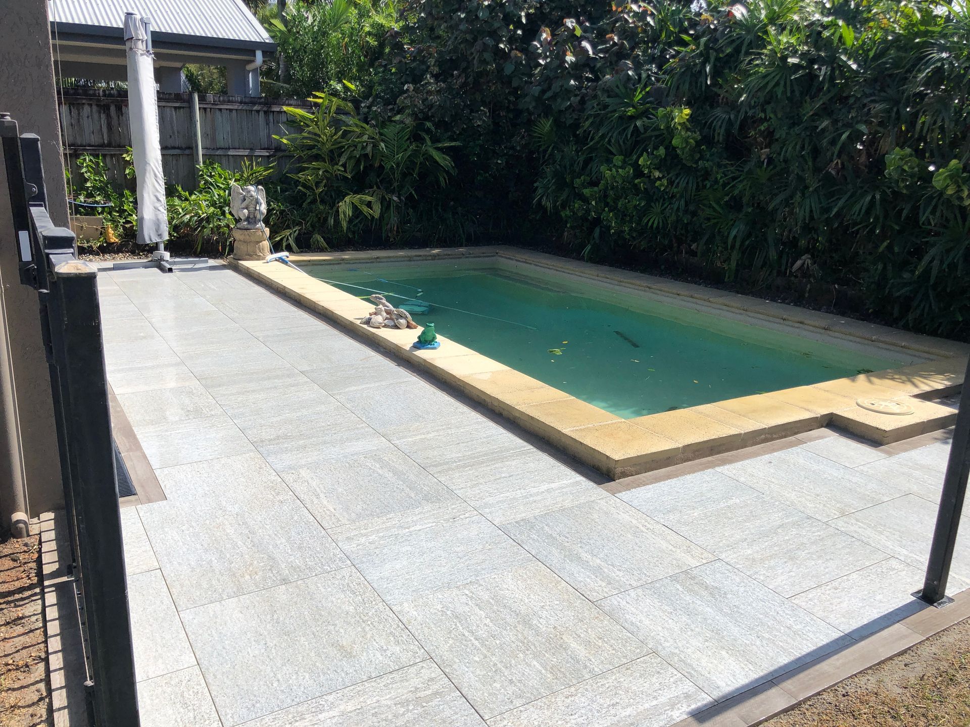 Natural stone pavers installed to pool area