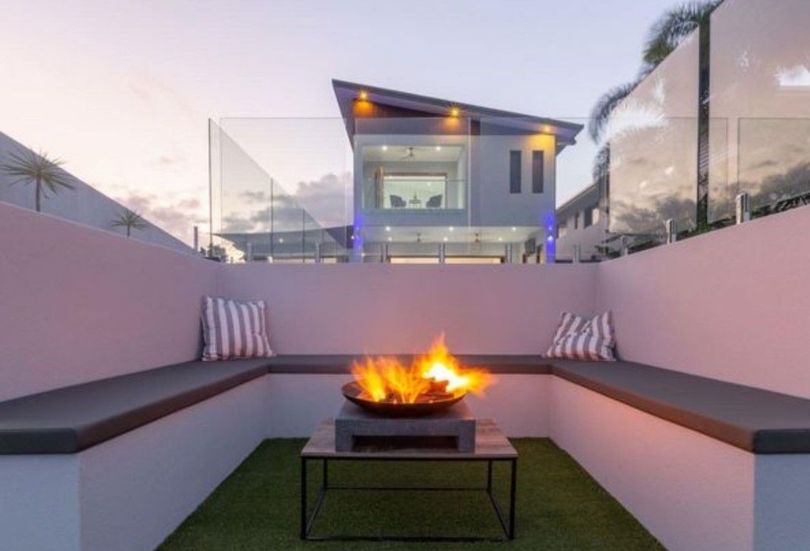 Besser block retaining wall and benches for fire pit area installed