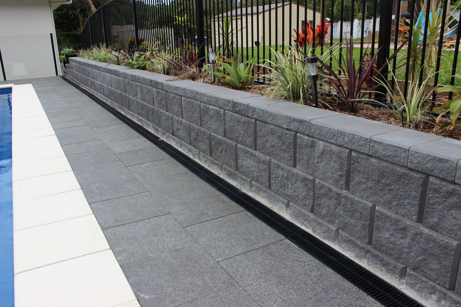 Austral Hastings retaining wall and natural stone pavers to pool area