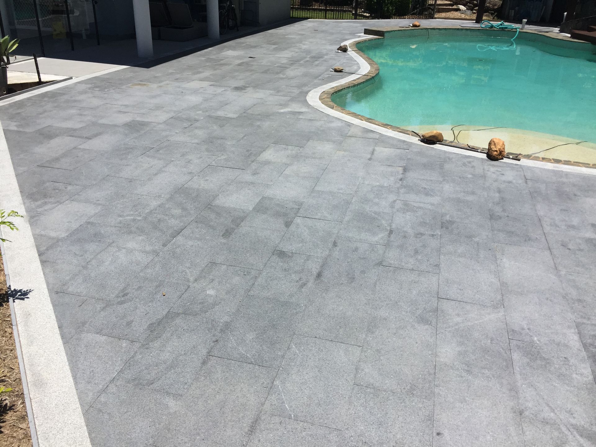 Natural stone pavers installed to pool area