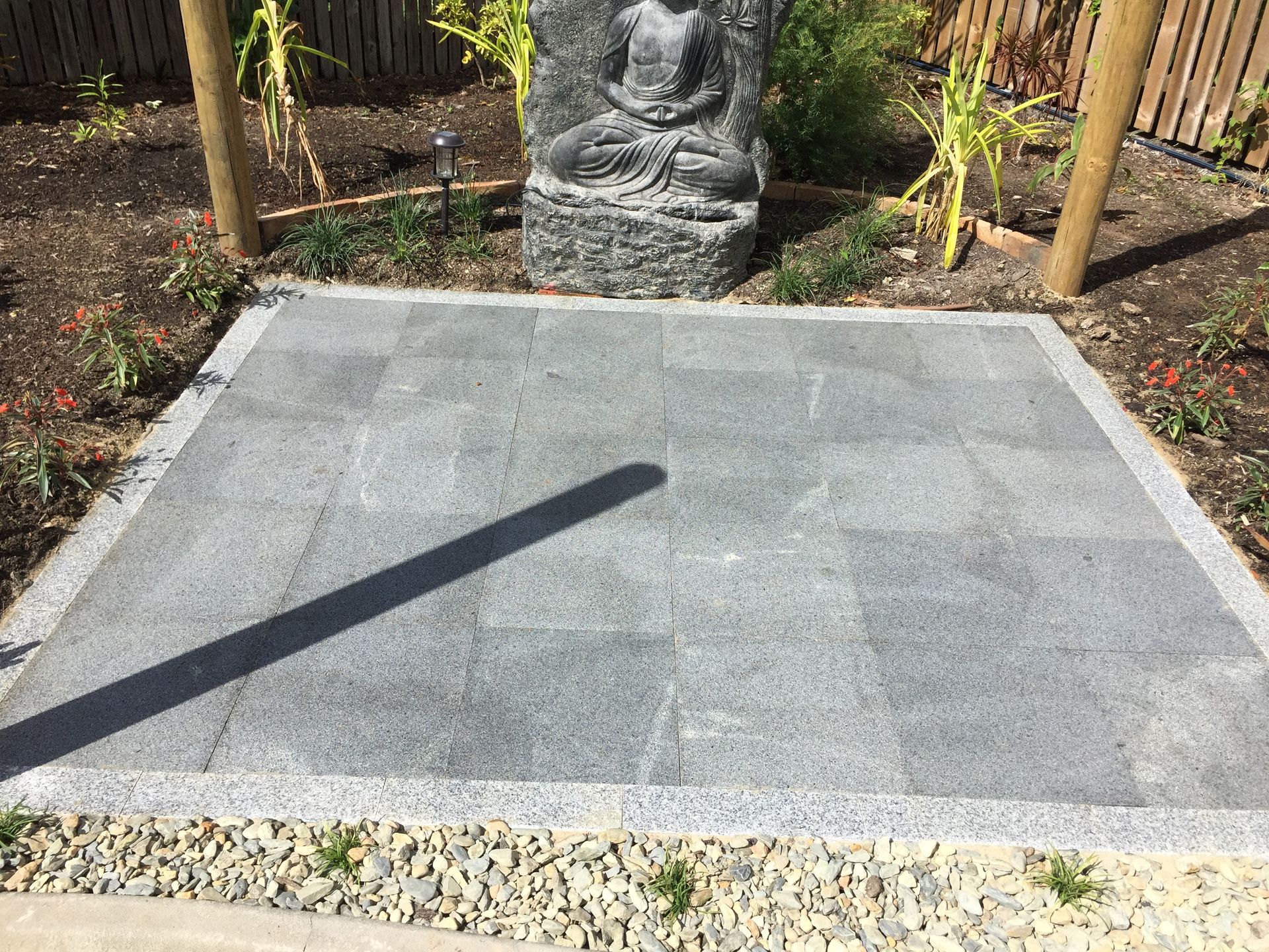 Natural stone pavers to create a memorial plaque in a garden installed