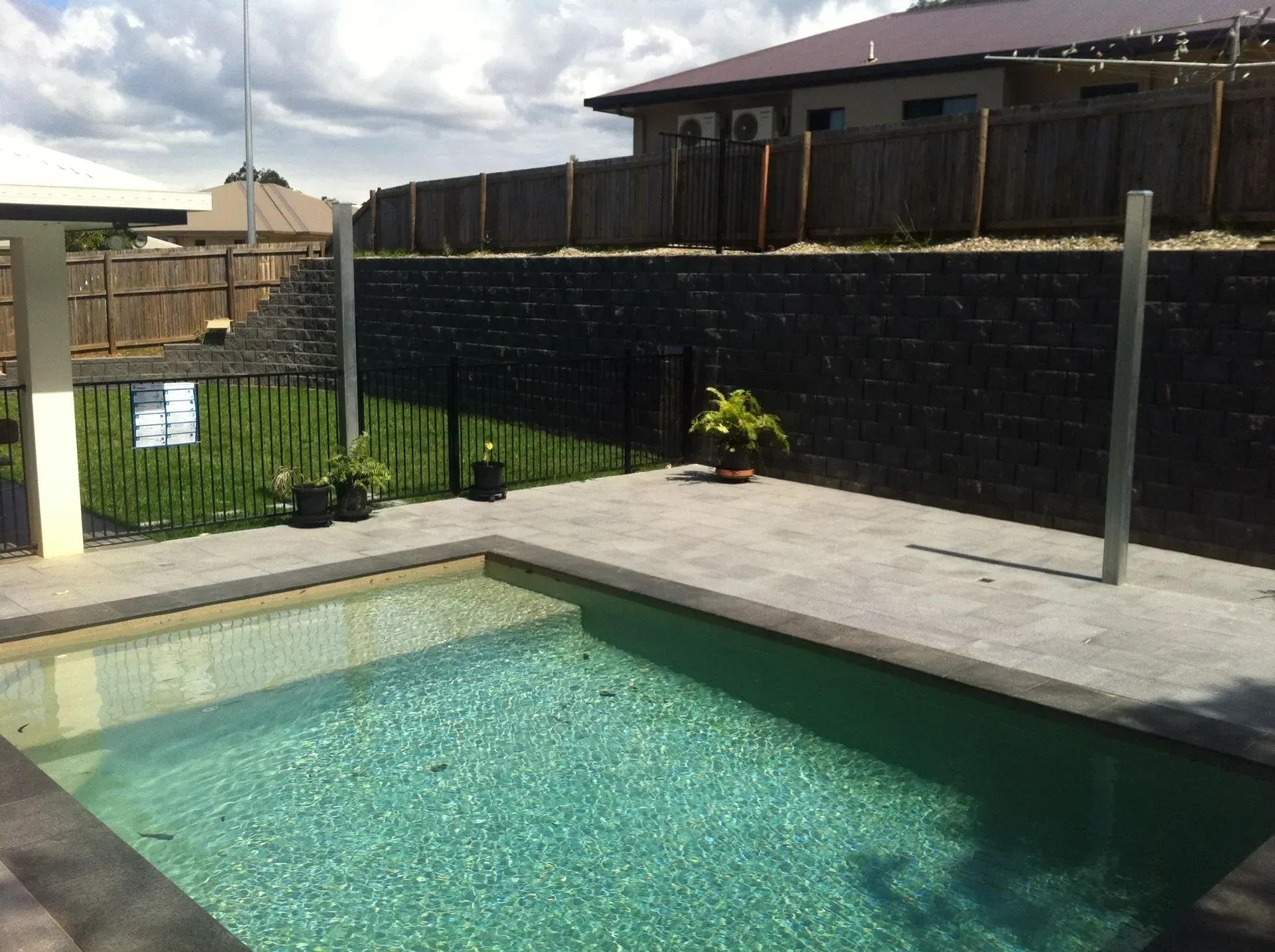 Besser block retaining wall beside a residential swimming pool in Cairns