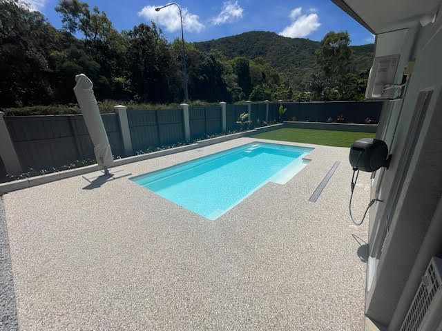Exposed aggregate pool deck around a Cairns pool