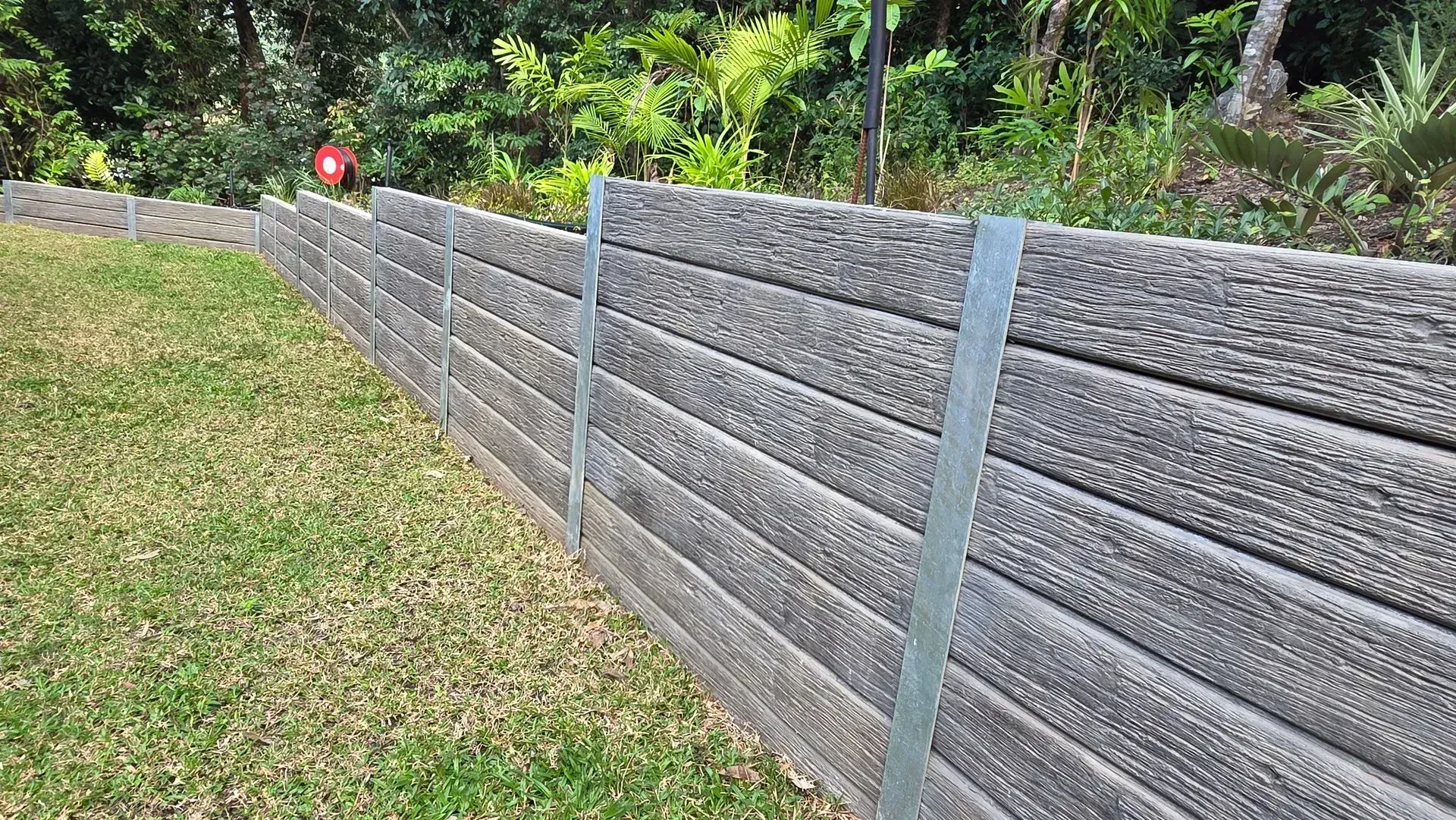 Exposed concrete driveway beside a Cairns home