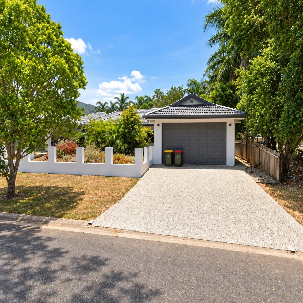 Exposed concrete driveway beside a Cairns home