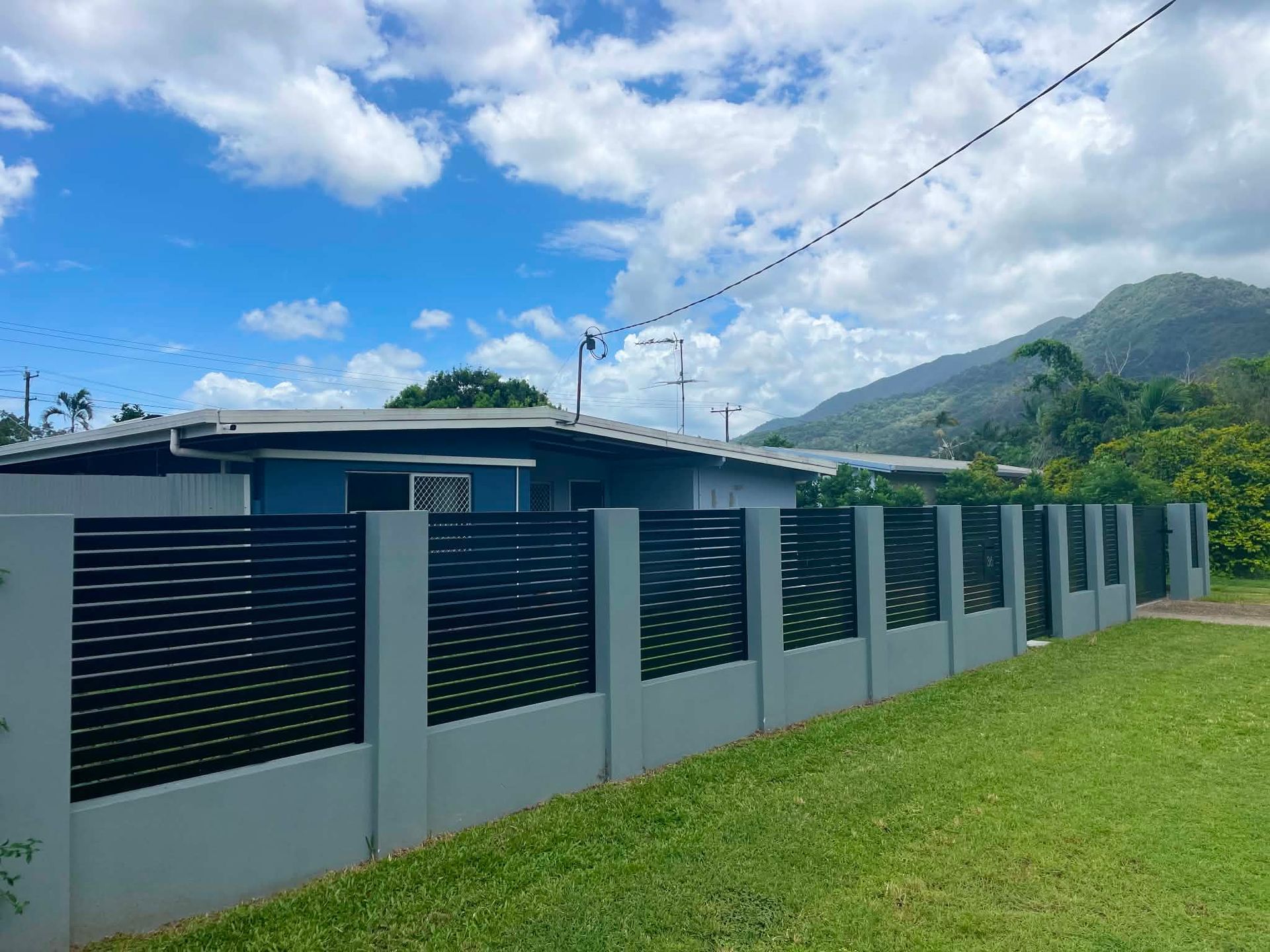 New besser block front fence with custom aluminium screens and gates installed