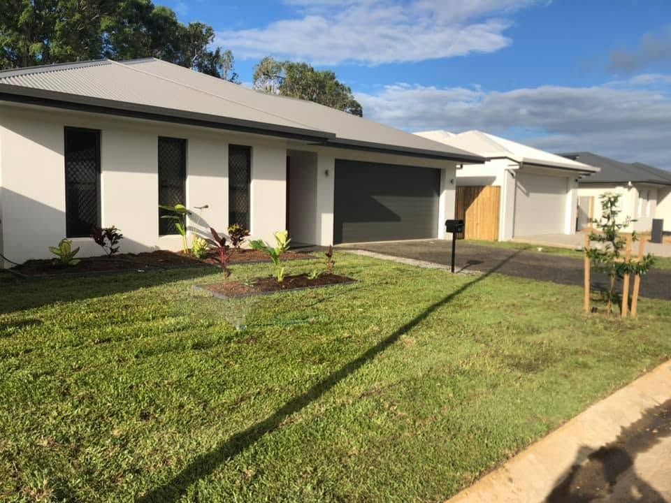 Exposed concrete driveway beside a Cairns home