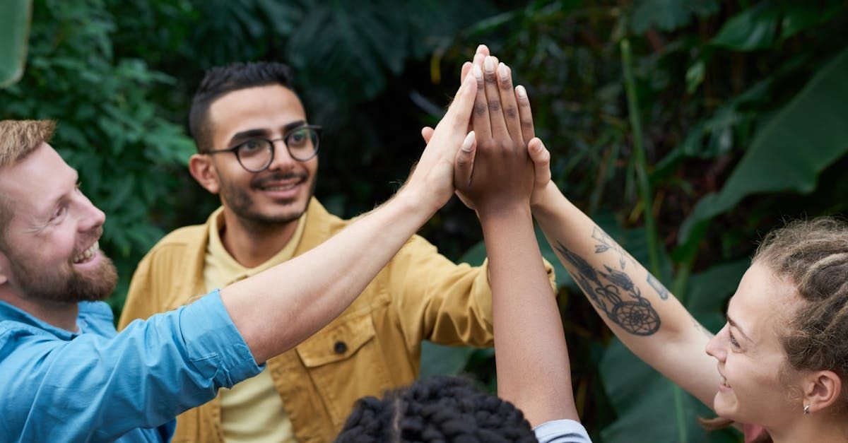 A group of people are giving each other a high five.