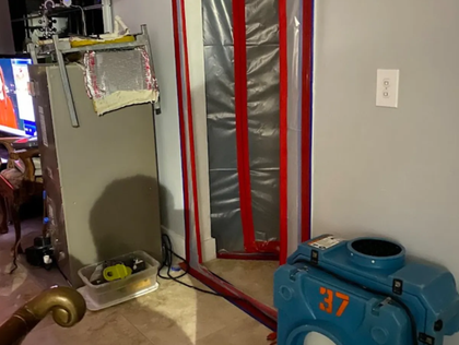 Indoor room with a gray cabinet, red-striped doorway, and blue machine labeled 37 in the foreground