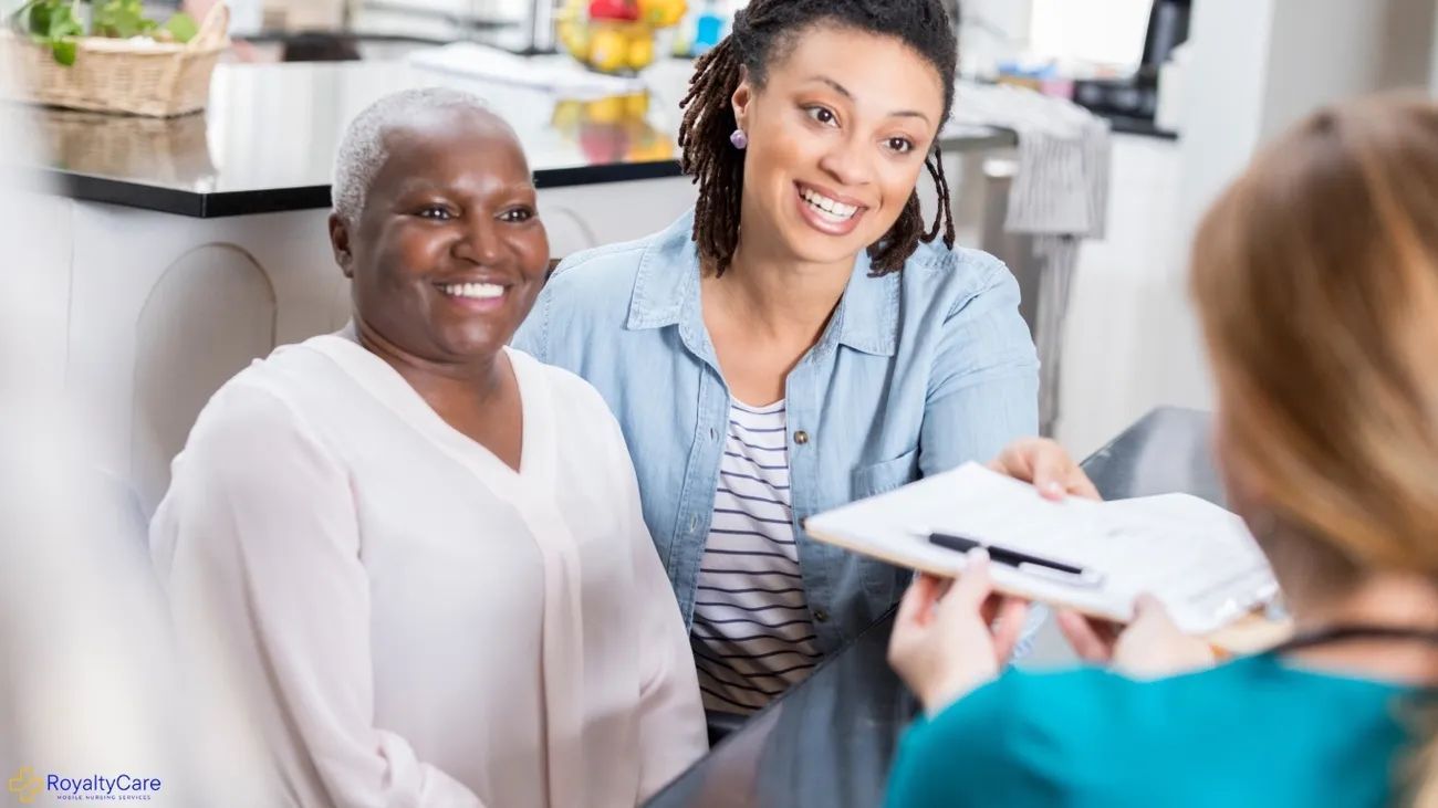 Two women smiling during a consultation with a doctor in a bright clinic office.