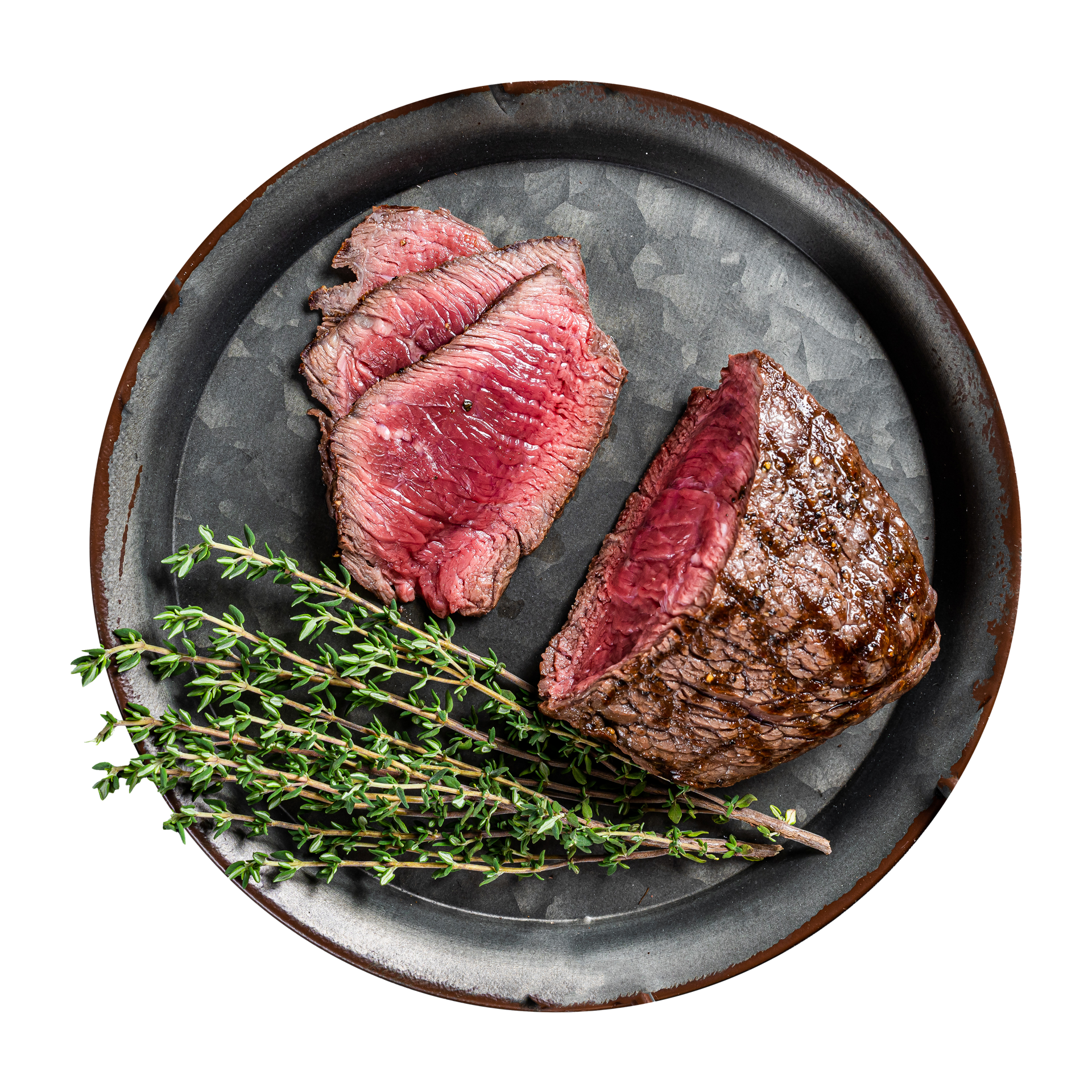 JPOT Japanese BBQ filet mignon cooked and partially sliced medium rare with herbs on a dark gray black plate bird's eye view