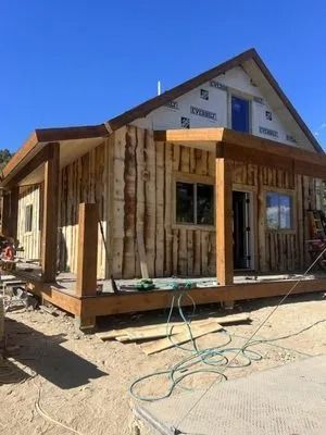 A small wooden house is being built in the desert.