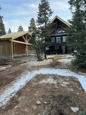 A large house is being built in the middle of a forest.