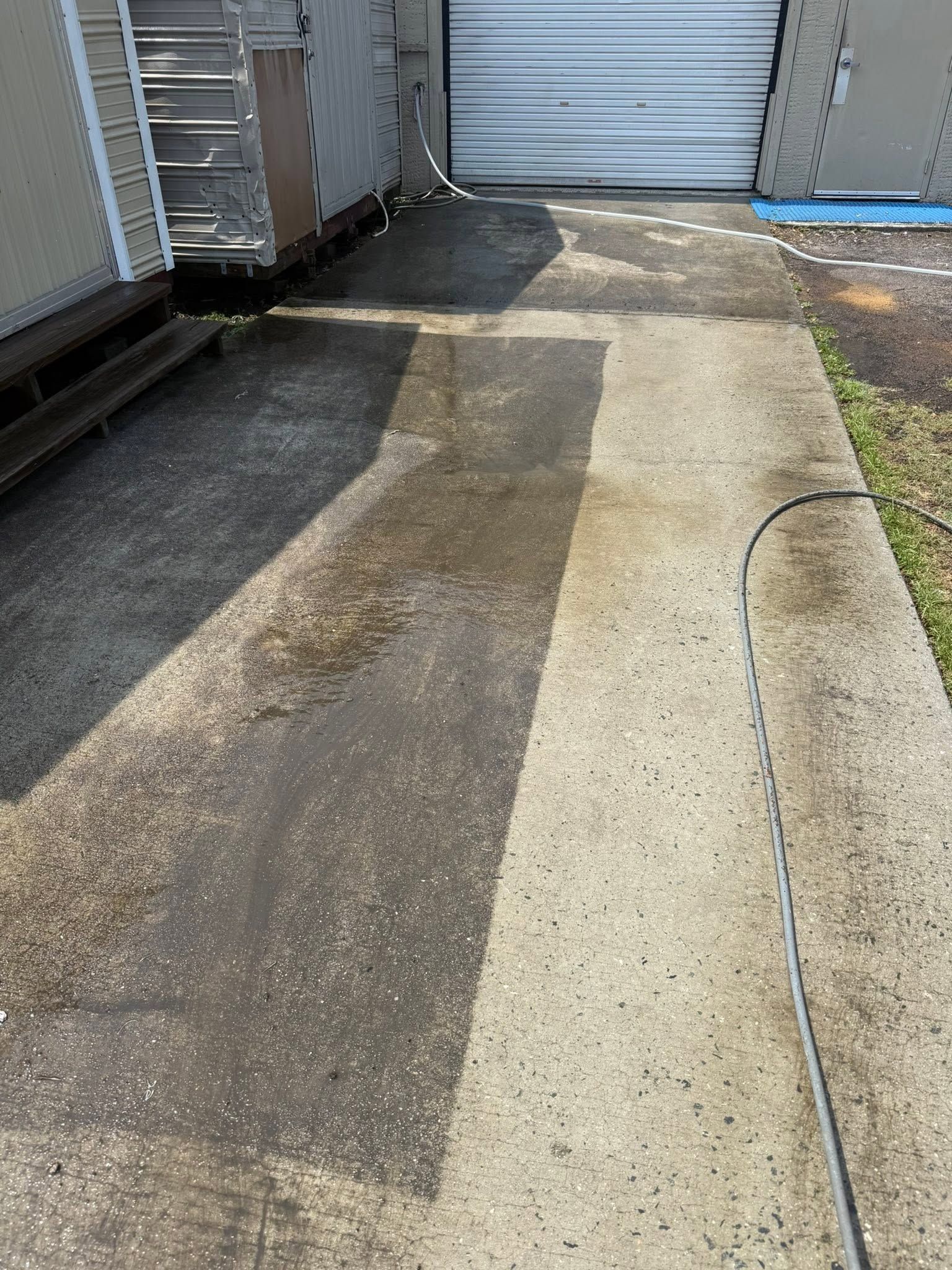 A man is using a high pressure washer to clean a roof.