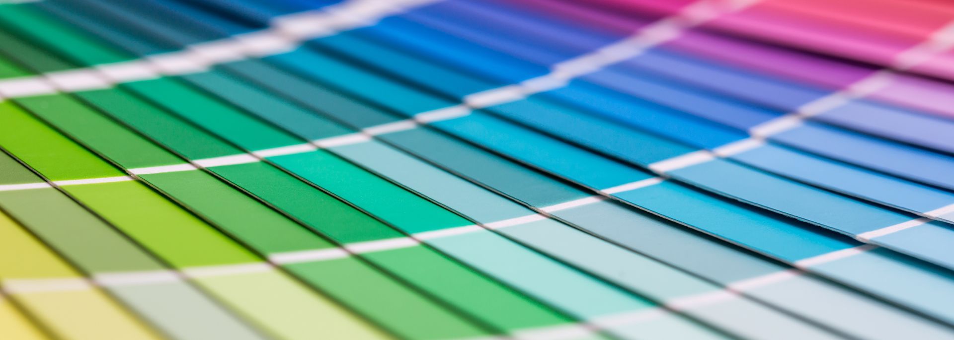 Curved rainbow-colored bands over a white grid background