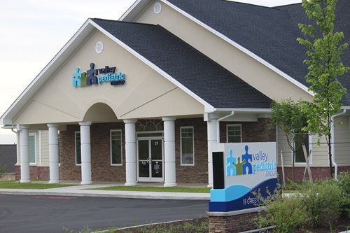 A light-colored building with the sign 