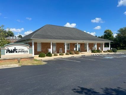 A brick building with a sign that reads 