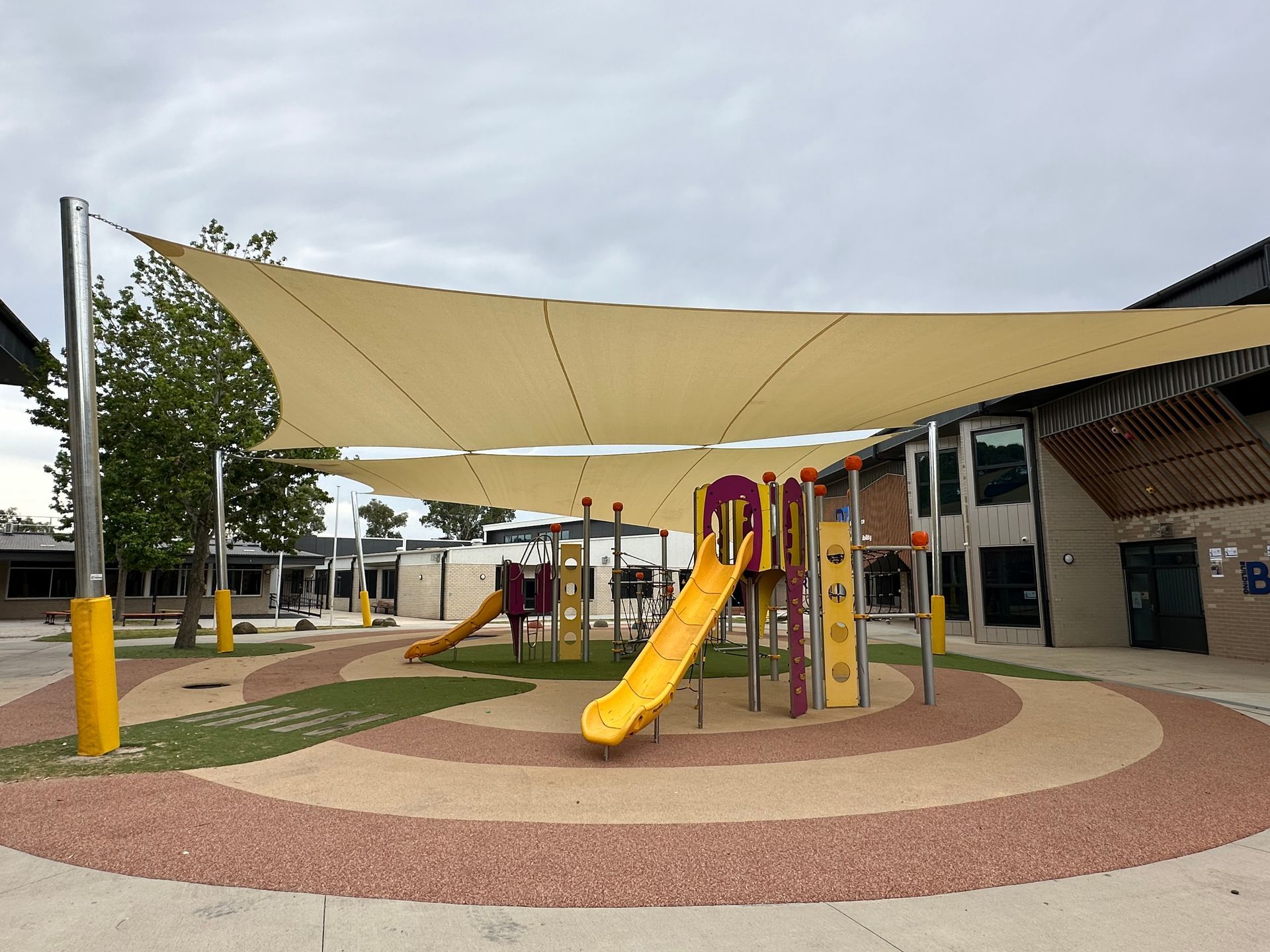 Commercial shade sail installation over a modern playground at Marnebek School in Cranbourne, providing sun protection for outdoor play areas and showcasing durable shade structures commonly used in Clyde, Clyde North, and surrounding suburbs by builders, landscapers, and school construction contractors.