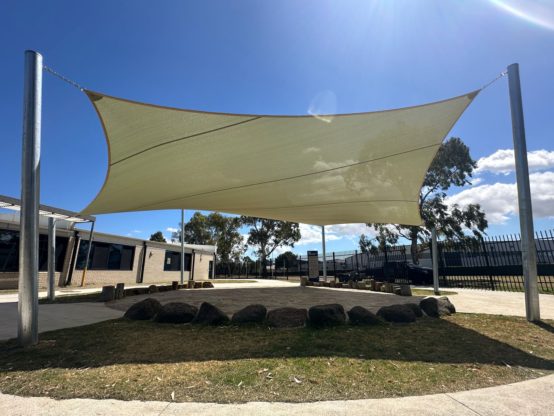 Shade sail installation at Marnebek School Cranbourne — custom outdoor structure by Sundance Shade Structures providing sun protection over outdoor landscaped play area