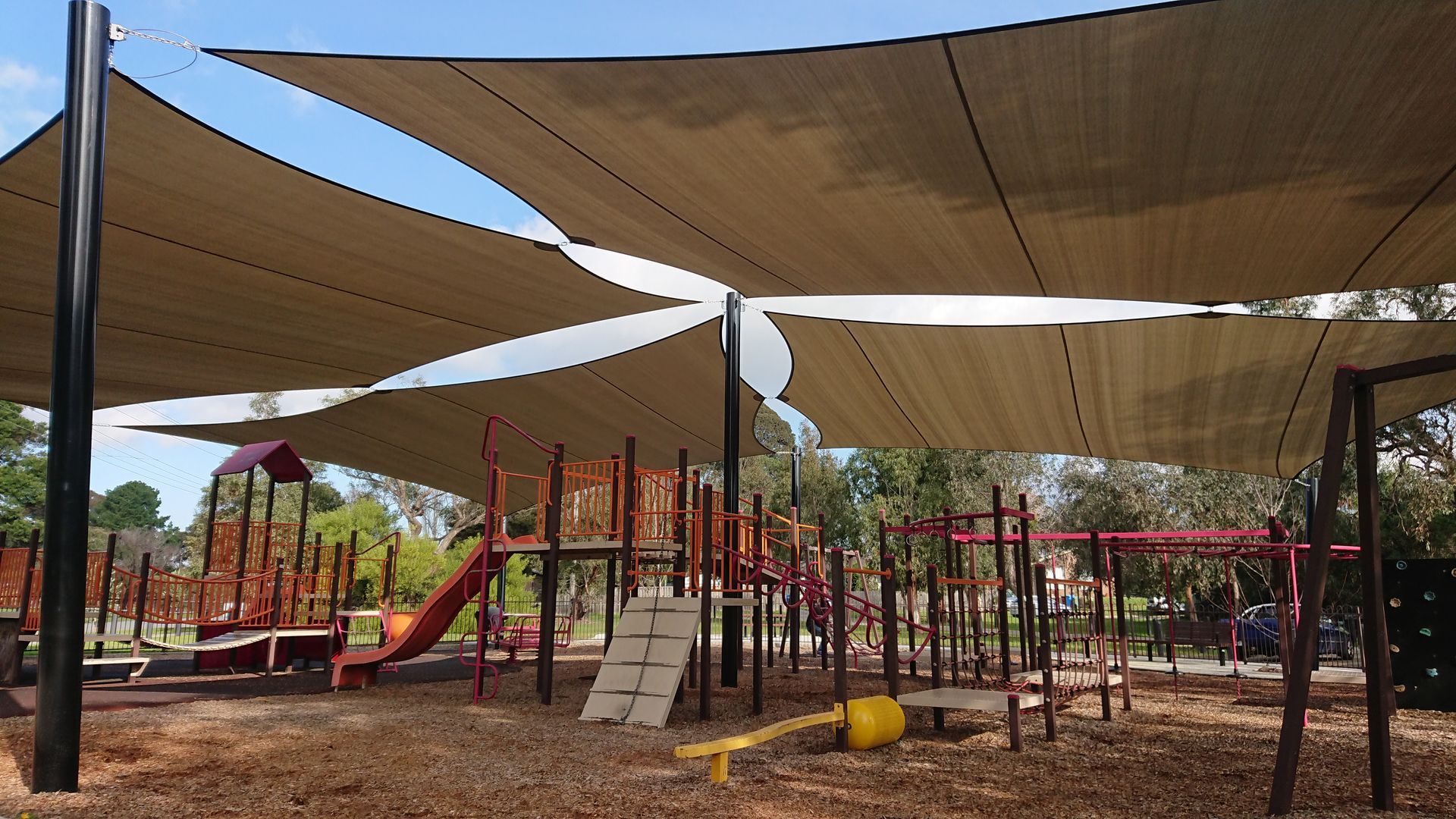 Commercial shade sail installation over a children’s playground at Junction Village Reserve in Cranbourne, featuring durable sun‑safe shade structures commonly used by builders, landscapers, and school contractors across Clyde, Clyde North, and surrounding suburbs.