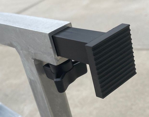 Black rubber foot attached to a silver metal sawhorse with a black knob.
