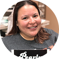 A woman wearing a gray shirt is smiling in a circle.