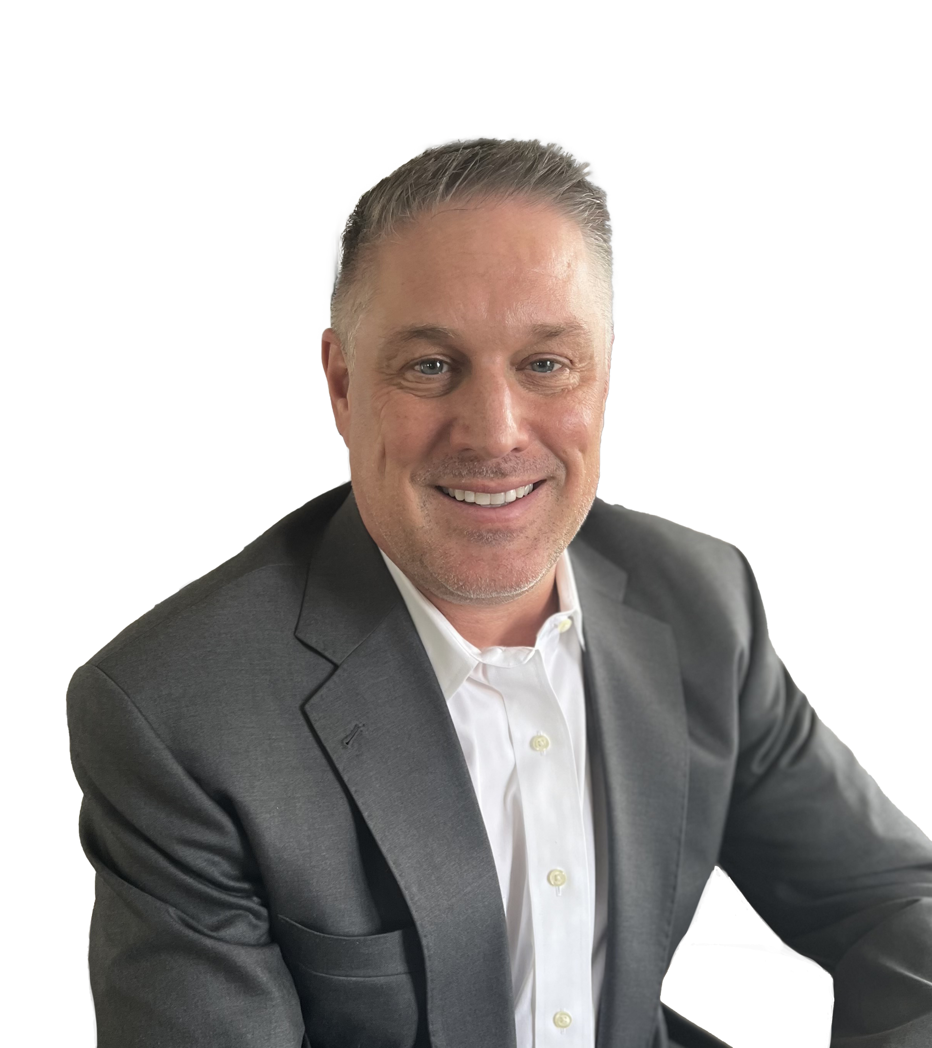 A man in a suit and white shirt is smiling for the camera.