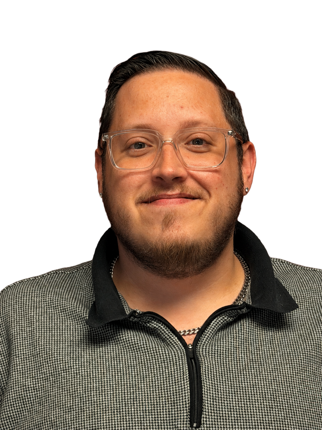 A man wearing glasses and a plaid shirt is standing in front of a white background.