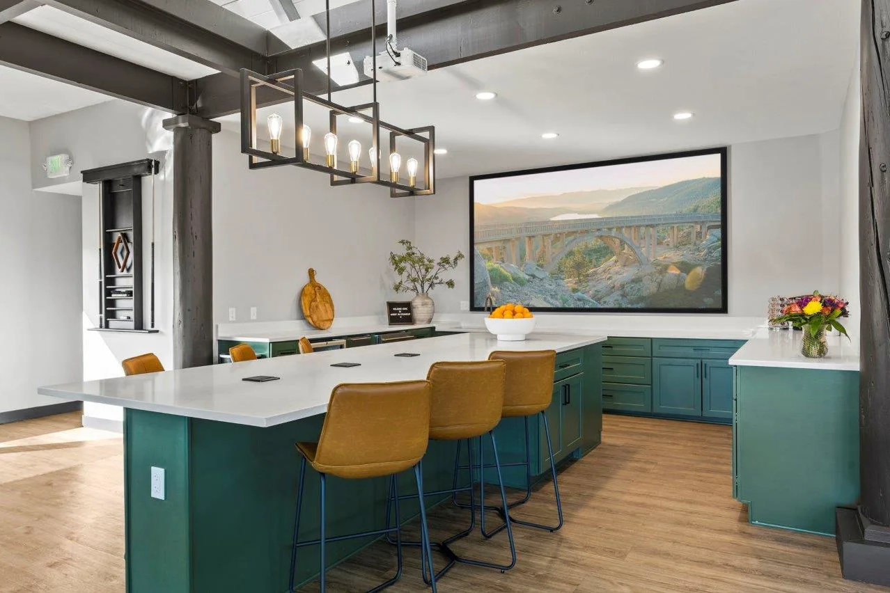 Ascent On Steamboat  kitchen with green cabinets , a large island , and a large painting on the wall.