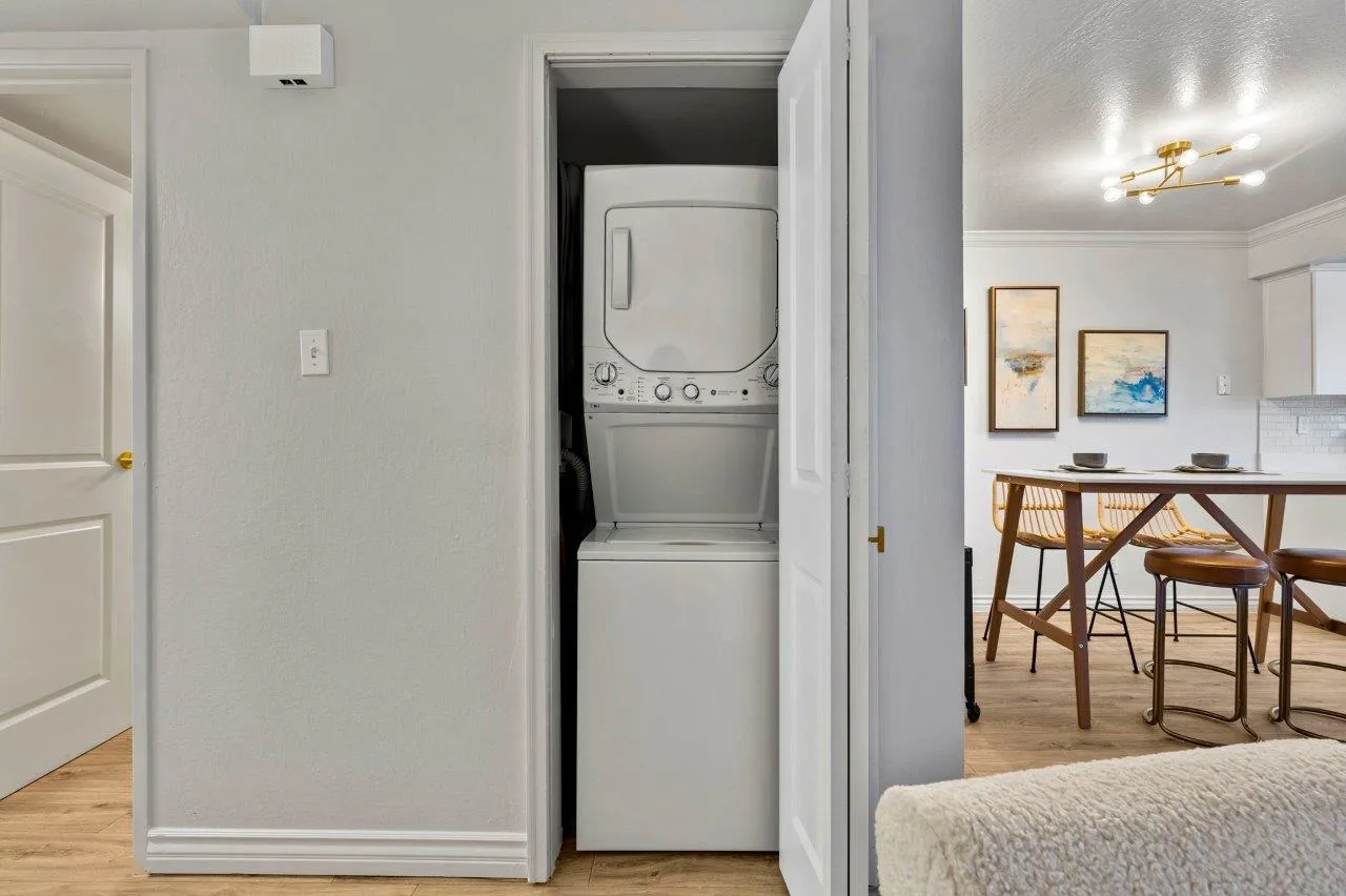Ascent On Steamboat  washer and dryer are stacked on top of each other in a closet.