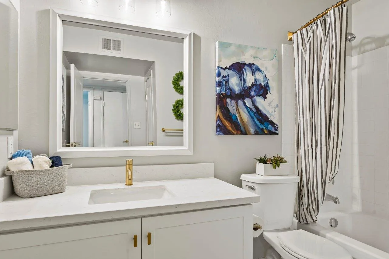 Ascent On Steamboat  bathroom with a sink , toilet , tub and mirror.
