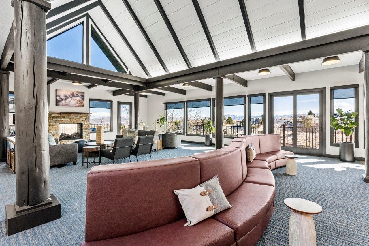 Ascent On Steamboat living room with a couch , chairs , and a fireplace.