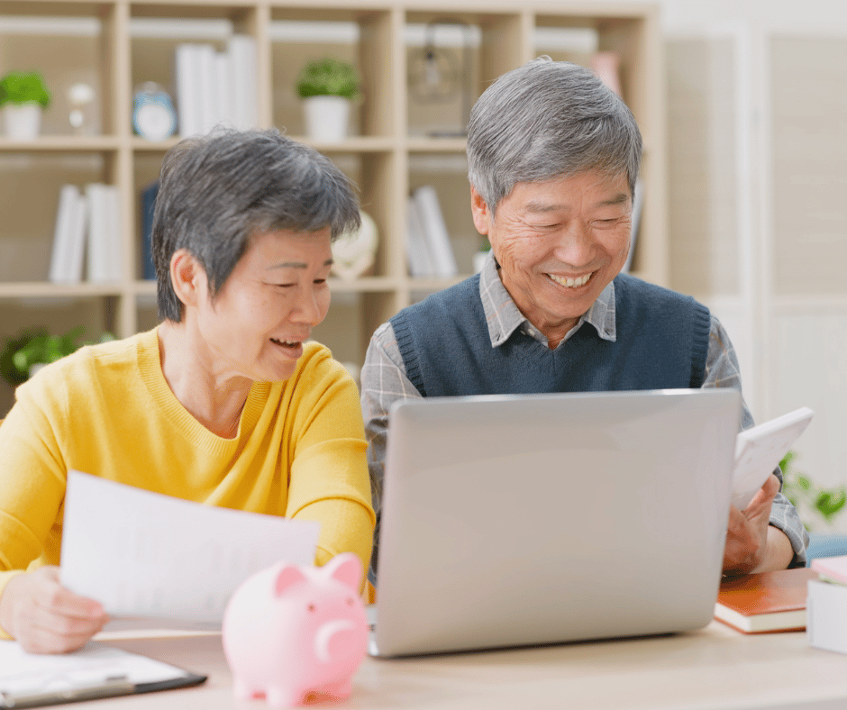 Picture of two medicare beneficiaries on a laptop review their Medicare options.