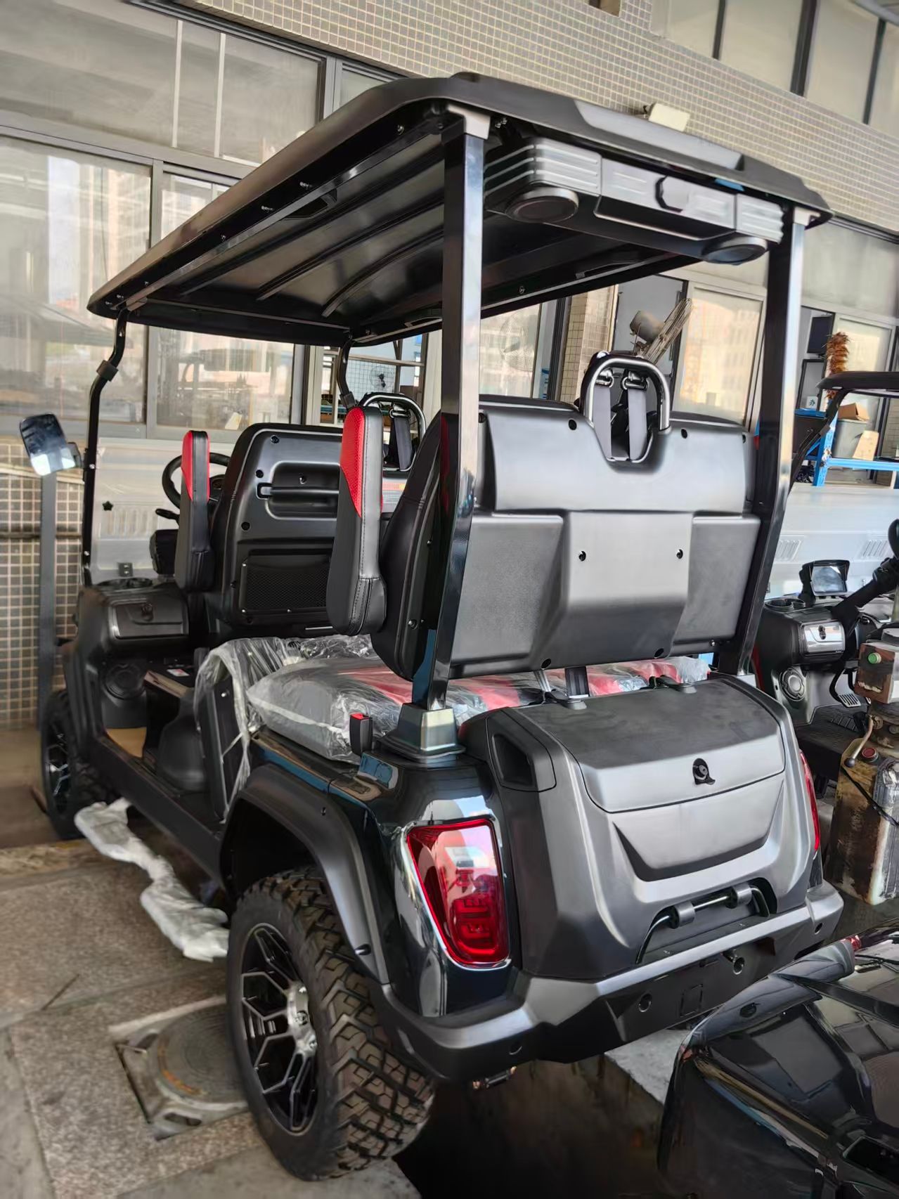 Black ATV front view with off-road tires, a bull bar, and