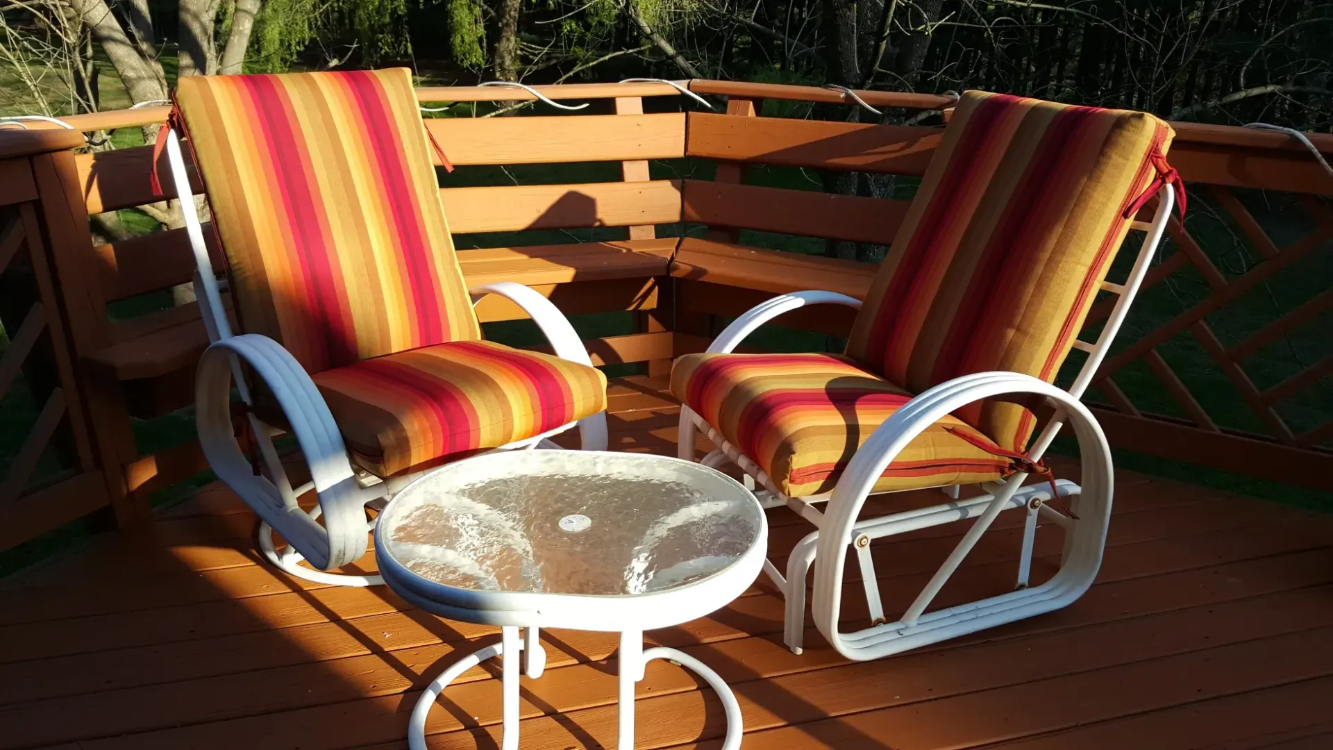 Two chairs and a table on a wooden deck