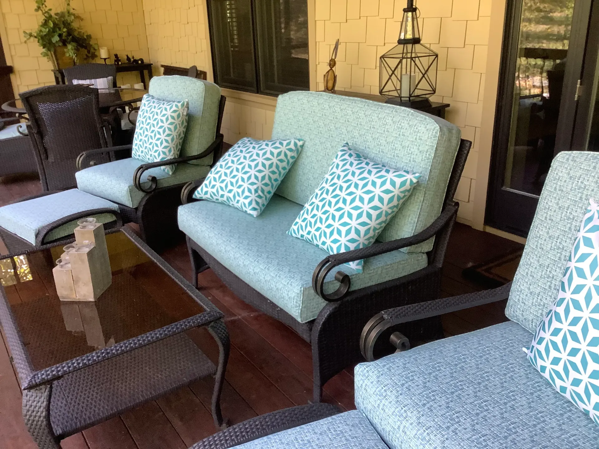 A patio with a couch , chairs and a table