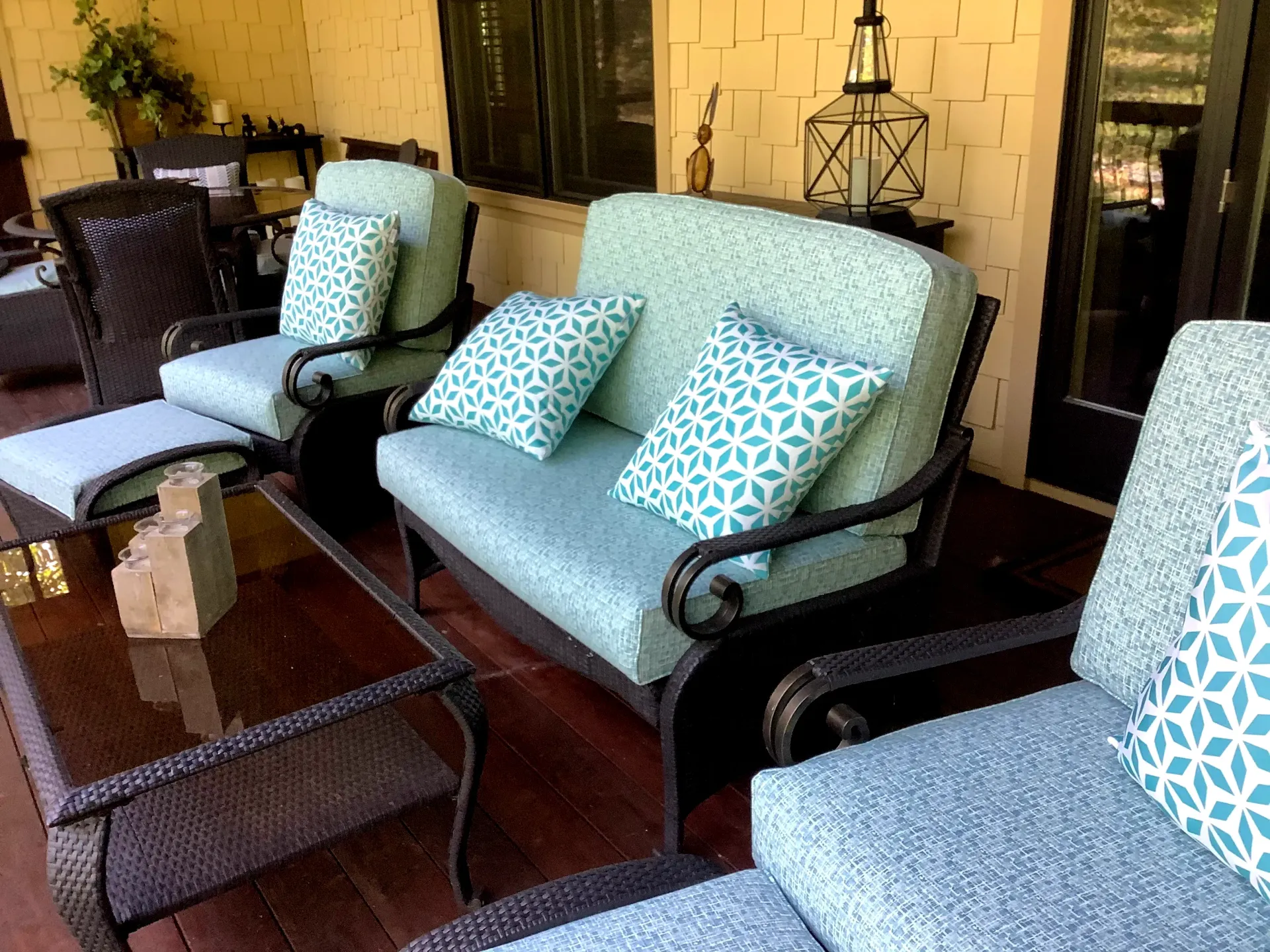 A patio with a couch , chairs , and a table.