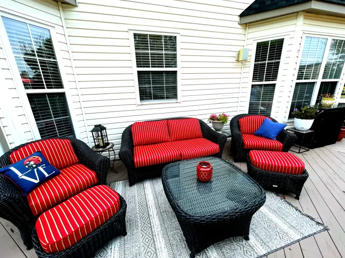A Lake Adela Patio Set with a couch lounge chairs and matching ottomans and table.