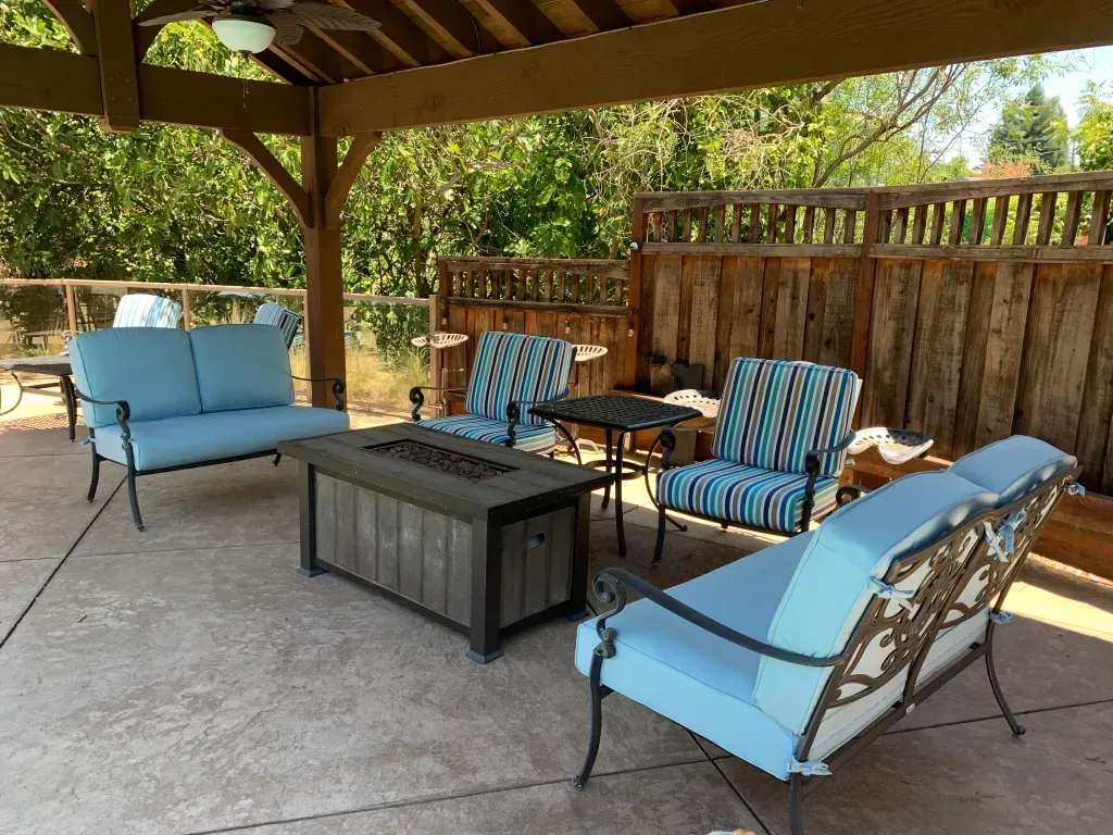 There is a fire pit in the middle of the patio.