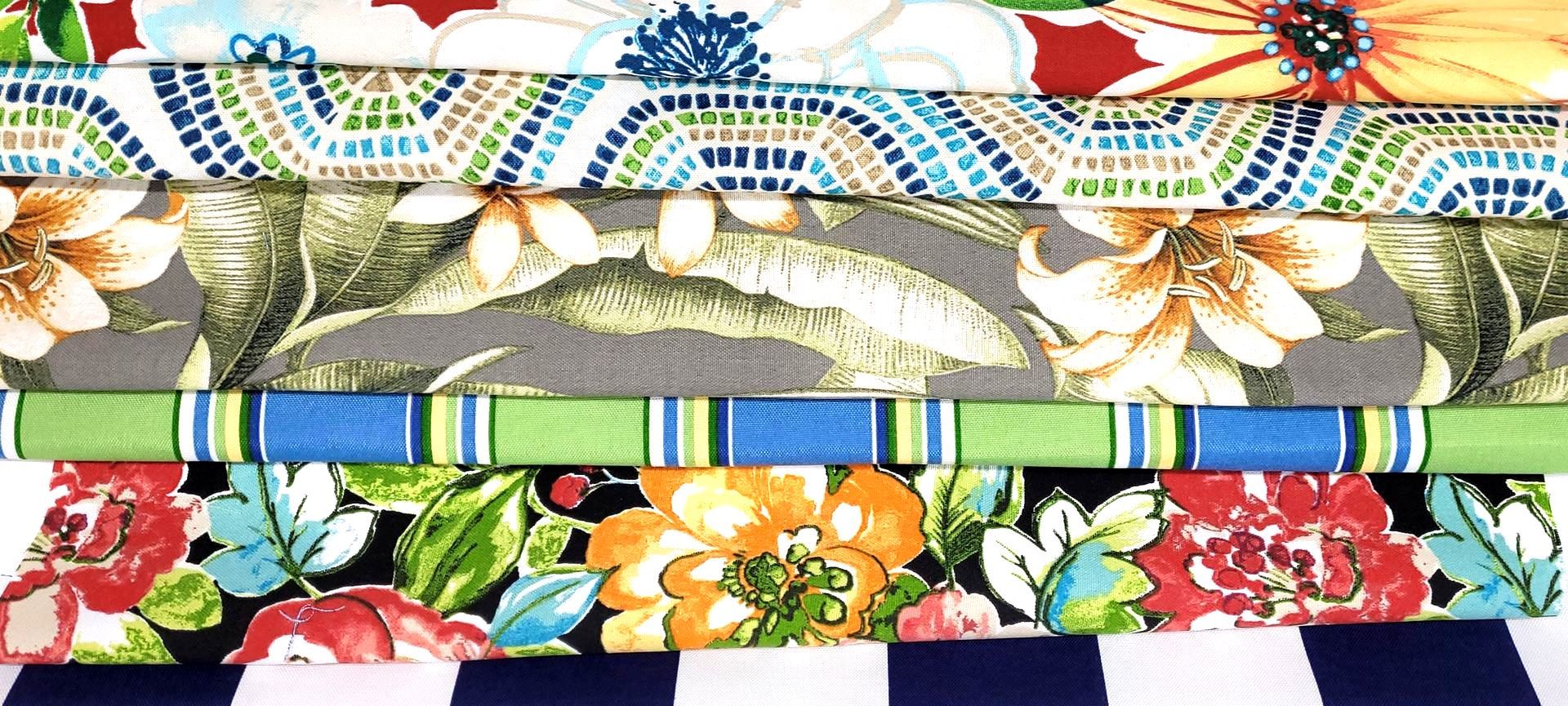 Stack of Sunbrella Fabrics in various colors folded and stacked on top of each other