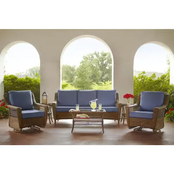 A living room with a couch , two chairs , and a coffee table.